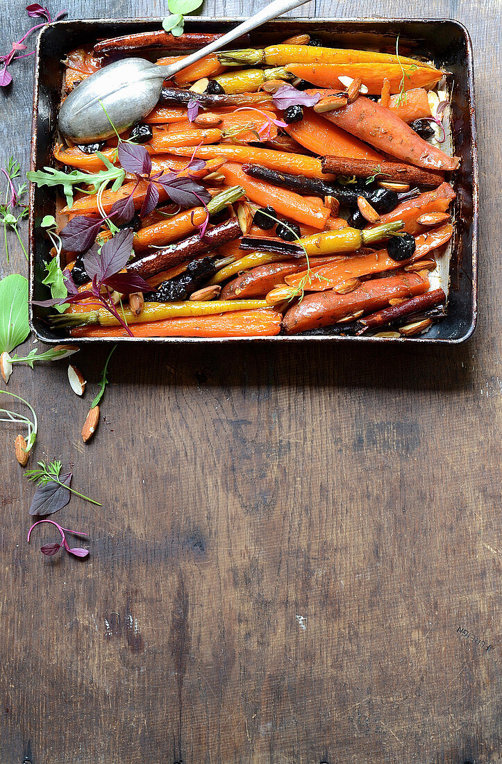 Roast sweet potato and carrot tzimmes with sour cherries and sticky orange syrup