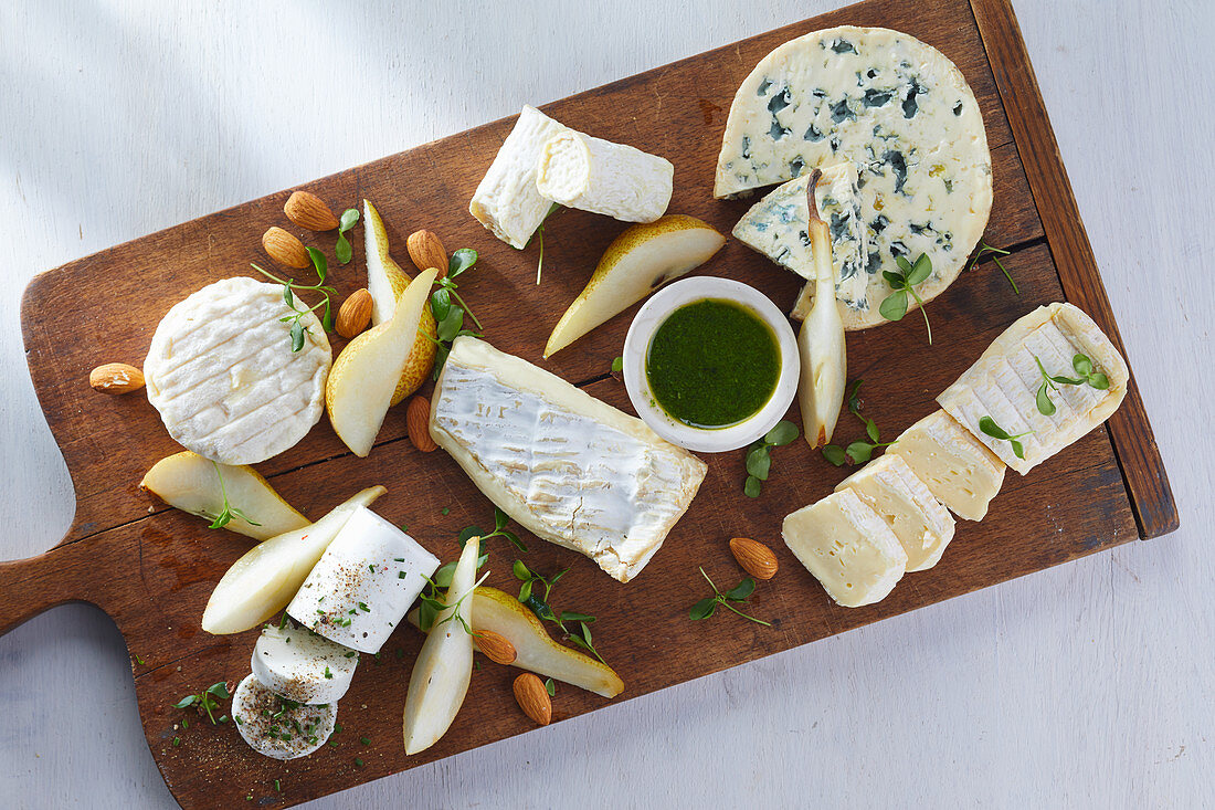 A cheese platter with pears and almonds