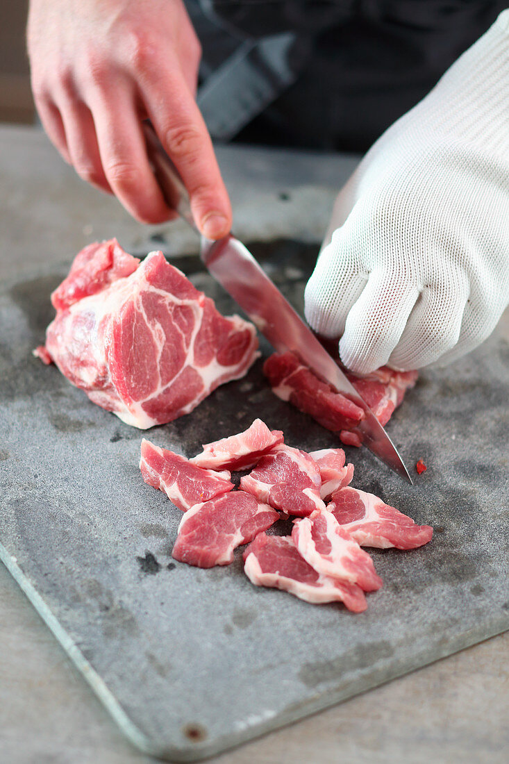 Pork collar being cut for gyros