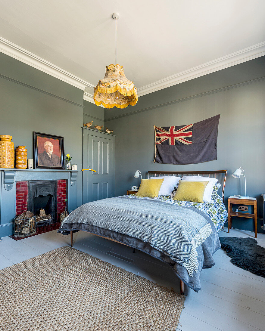 Bedroom with grey walls and mustard-yellow accents