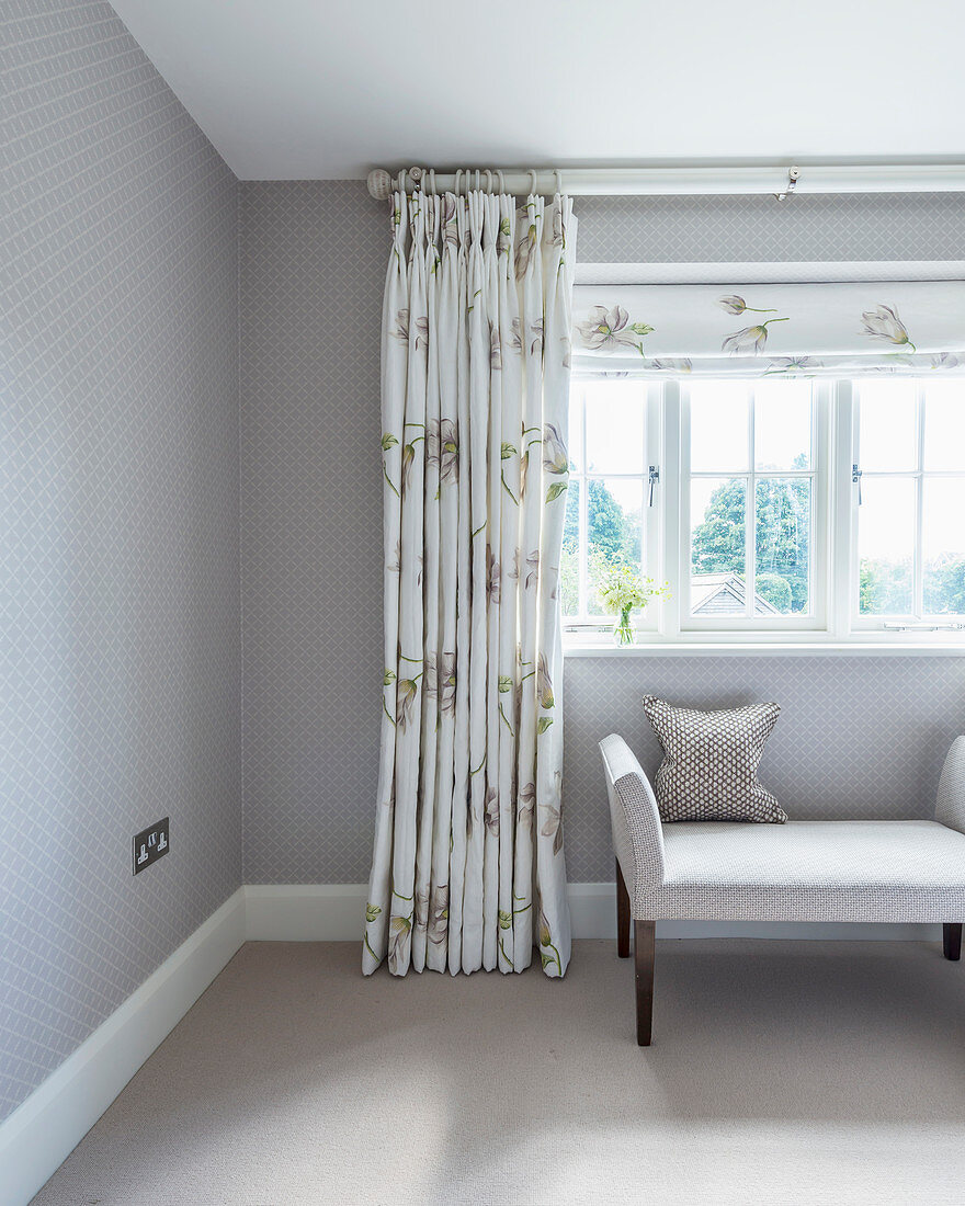 Couch below window with classic curtains