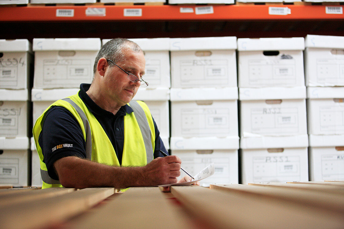 Worker in removals and storage facility