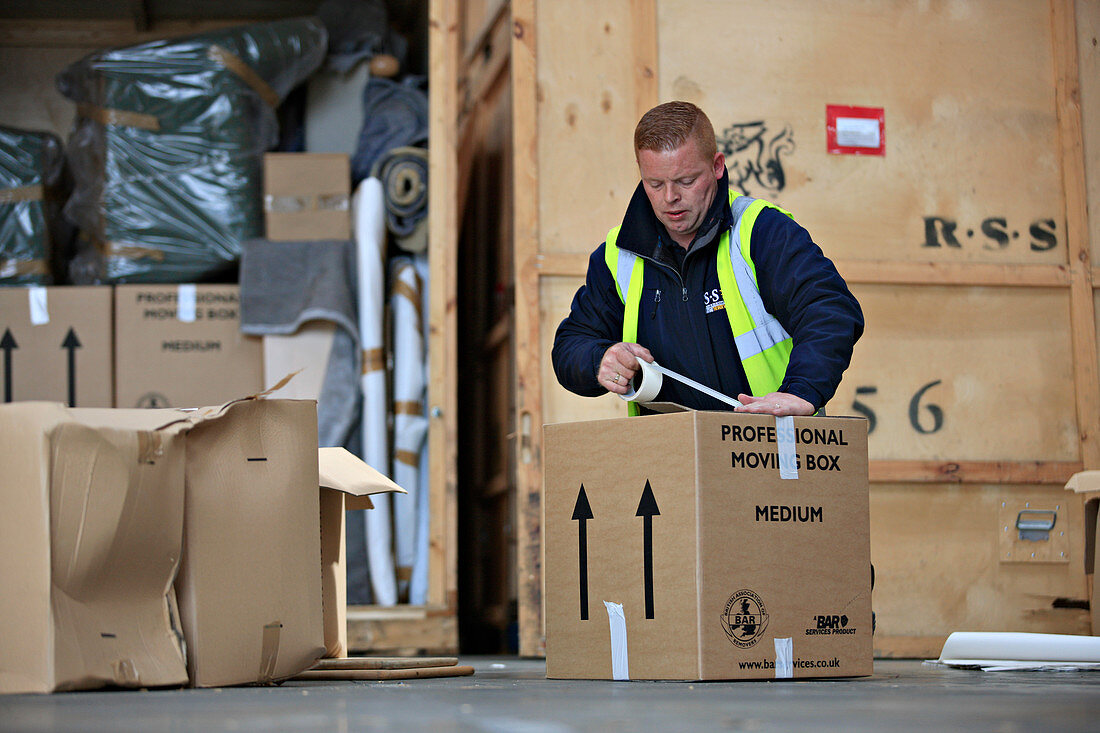 Packing boxes at removals and storage facility
