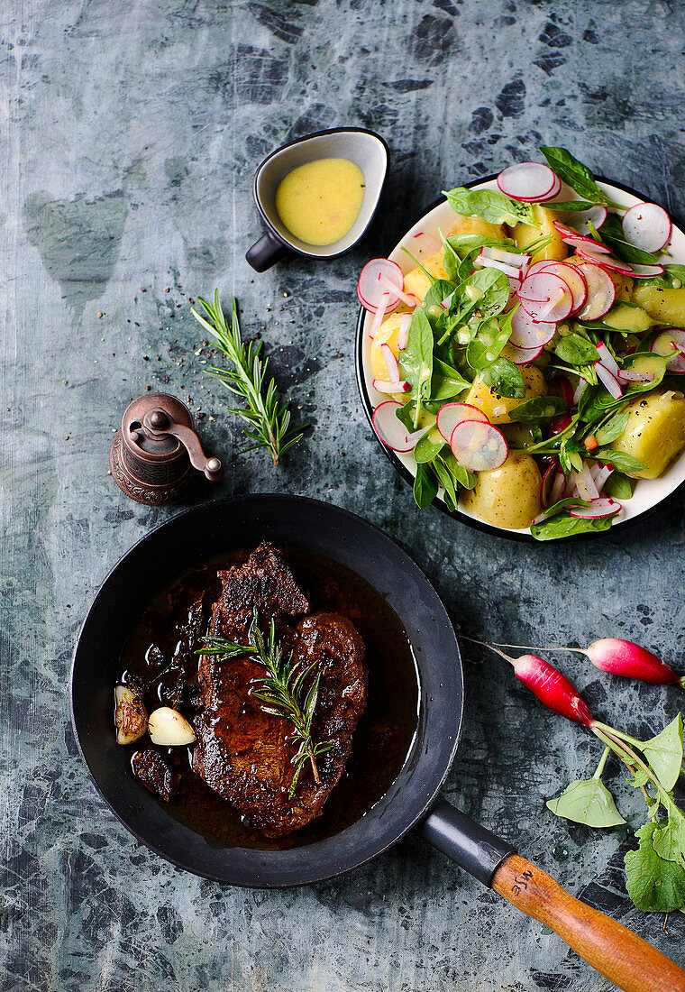 Steak with potato salad