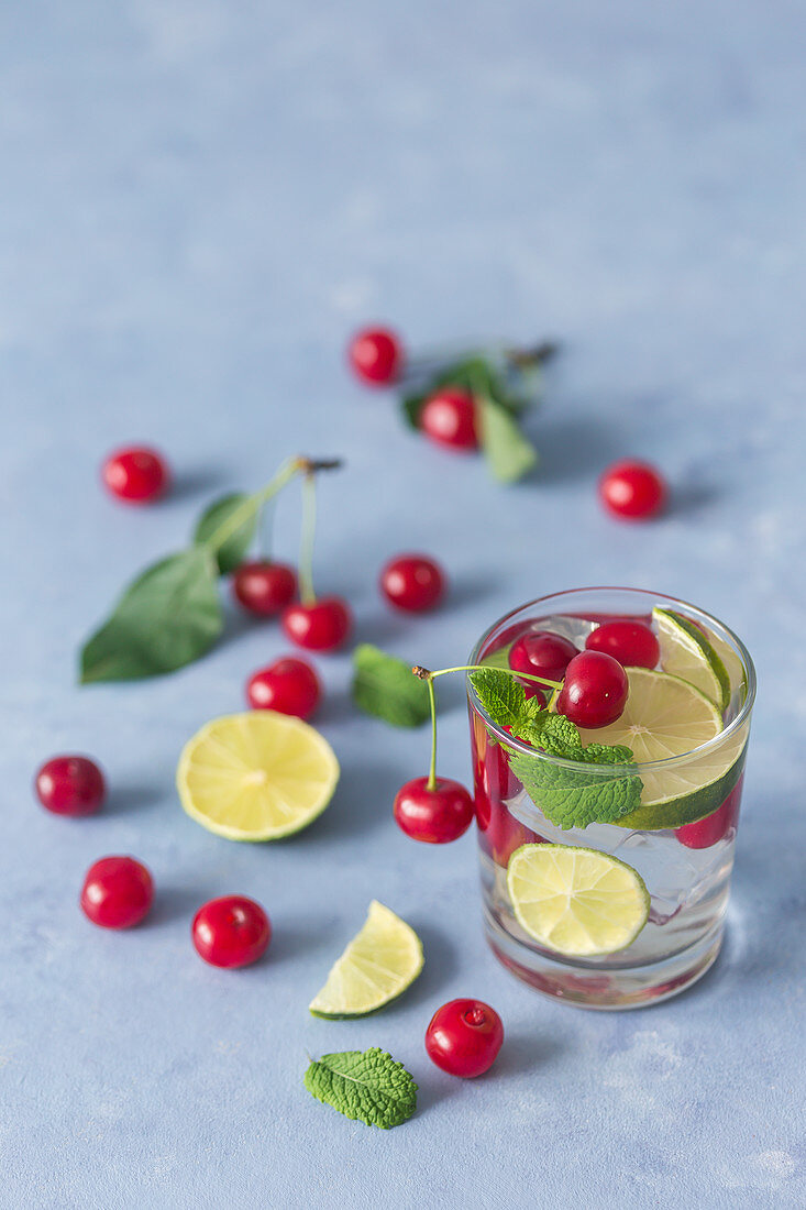 Mojito with cherries, lime slices and mint