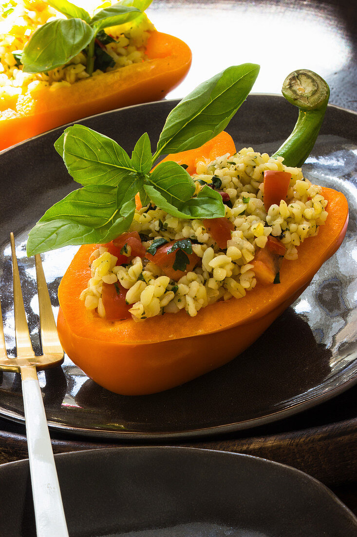Bulgur salad with tomatoes and herbs served in a pepper
