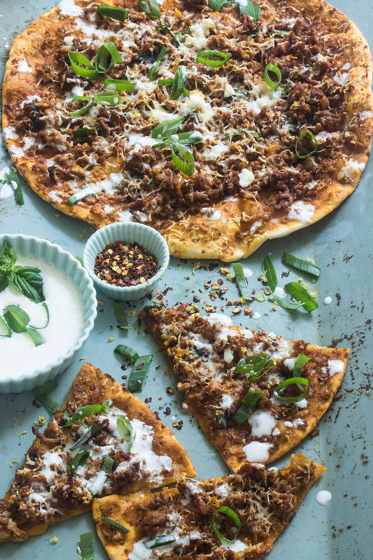 Manakish (Lebanese pizza) with minced lamb and yoghurt sauce