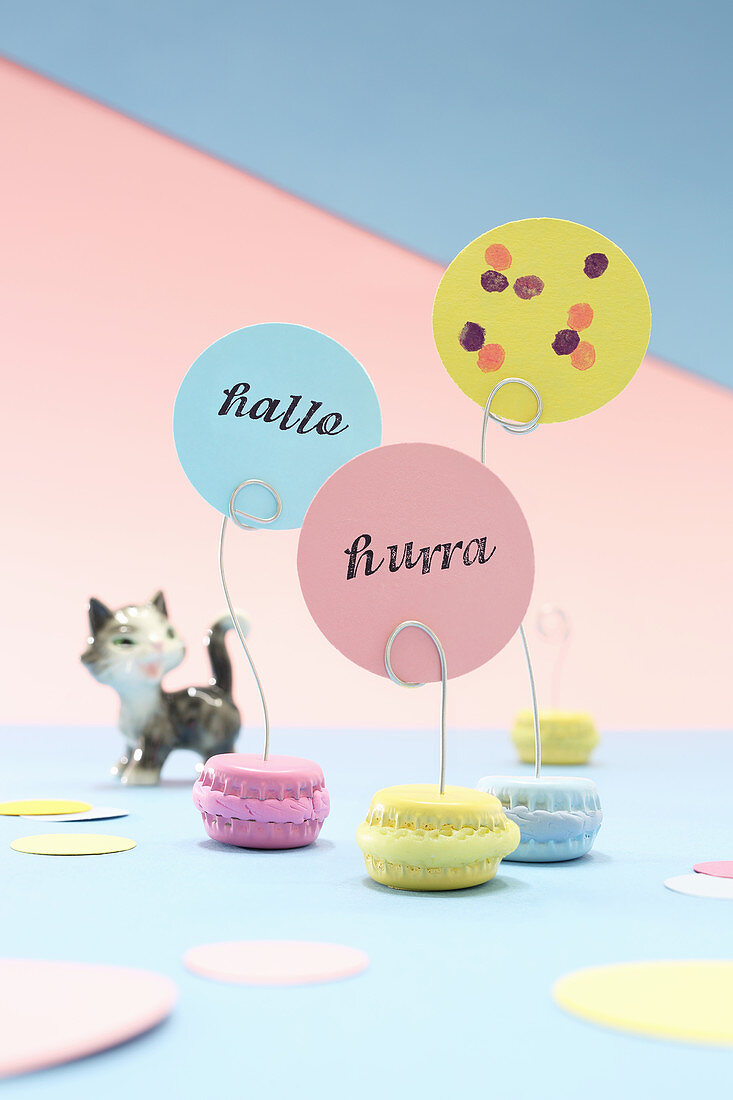 DIY macaron-shaped place-card holders made from bottle caps