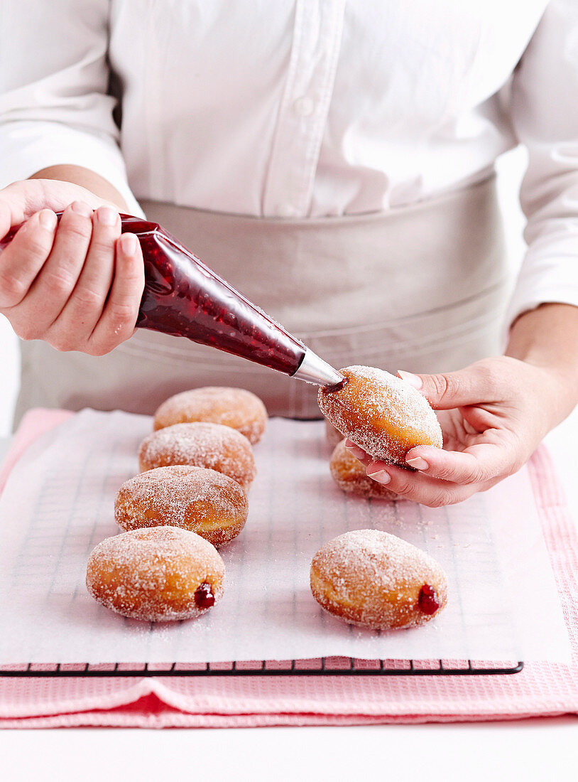 Filling Doughnuts with jam