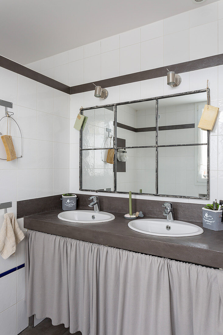 Washstand with twin sinks and curtained front in bathroom