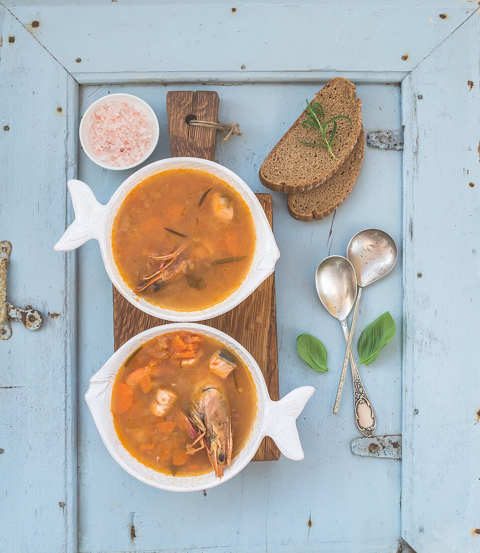 French Bouillabaisse fish tomato soup with salmon fillet, shrimp and spices