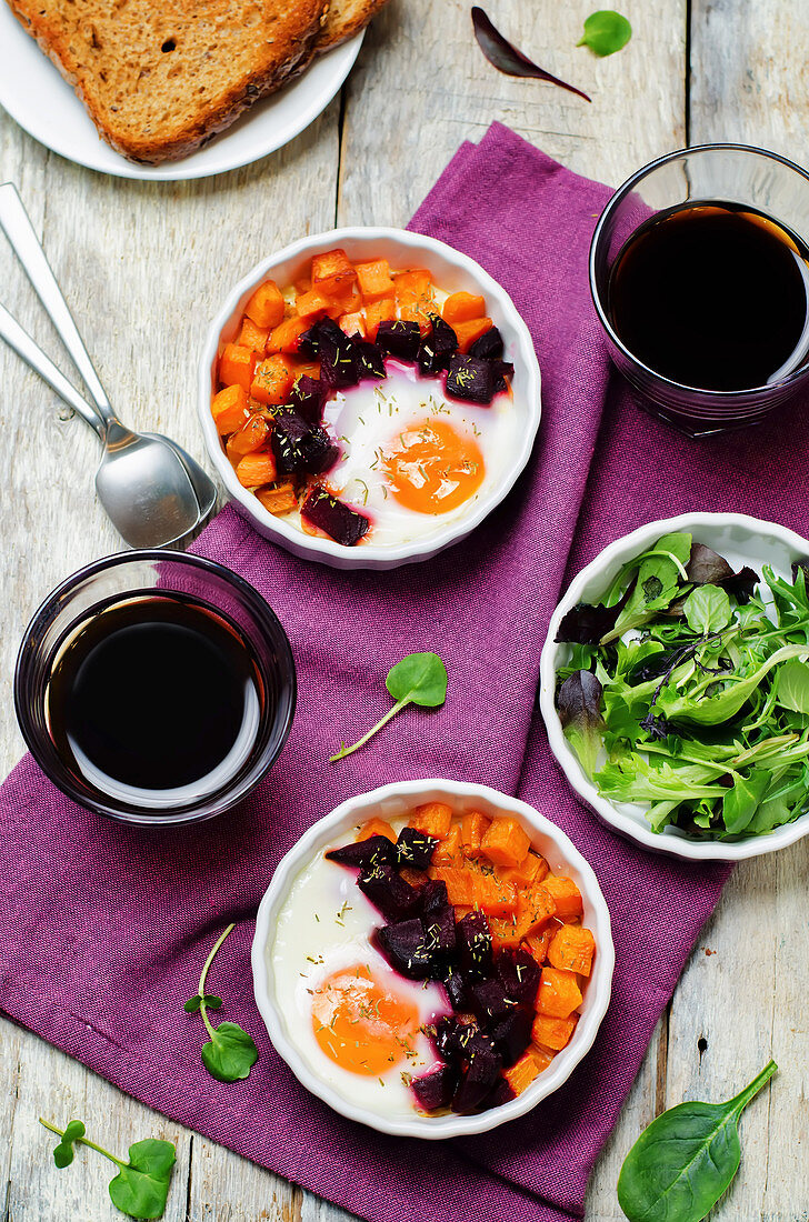 Beet Sweet potato baked eggs on a wood background