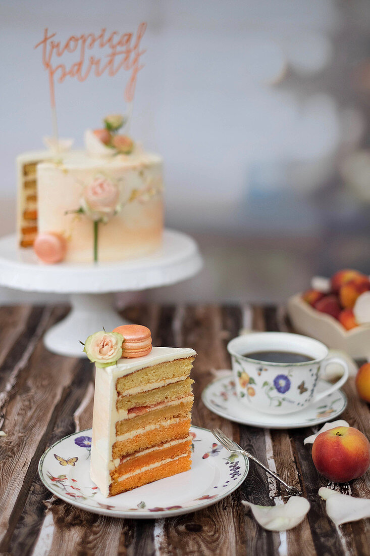 A festive peach cake with peach macaroons and roses