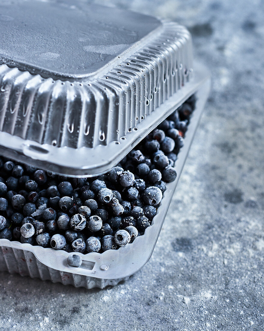 Frozen blueberries in a plastic container