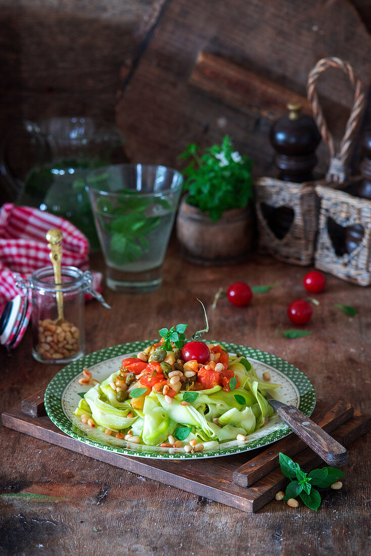 Zucchini noodles with tomatoes and pine nuts