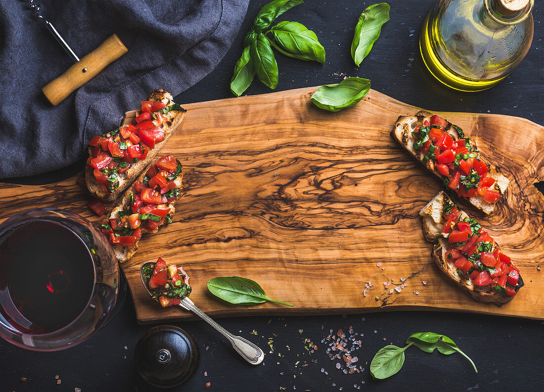 Tomato and basil bruschetta with glass of red wine
