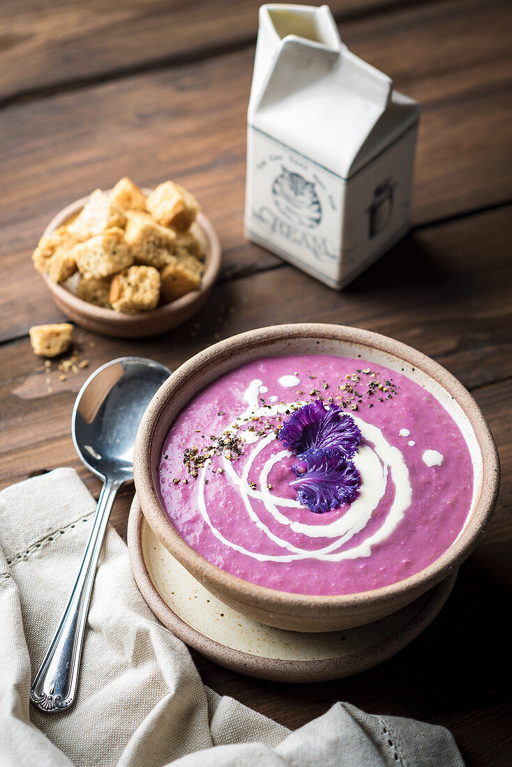 Cream of purple cabbage soup with croutons and cream