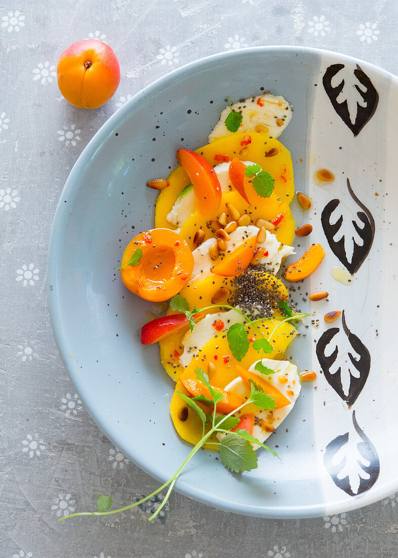 Apricot and mango caprese with mint and pinenuts
