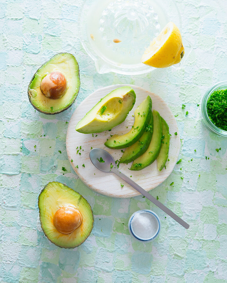 Avocado, halved and sliced with lemon and parsley