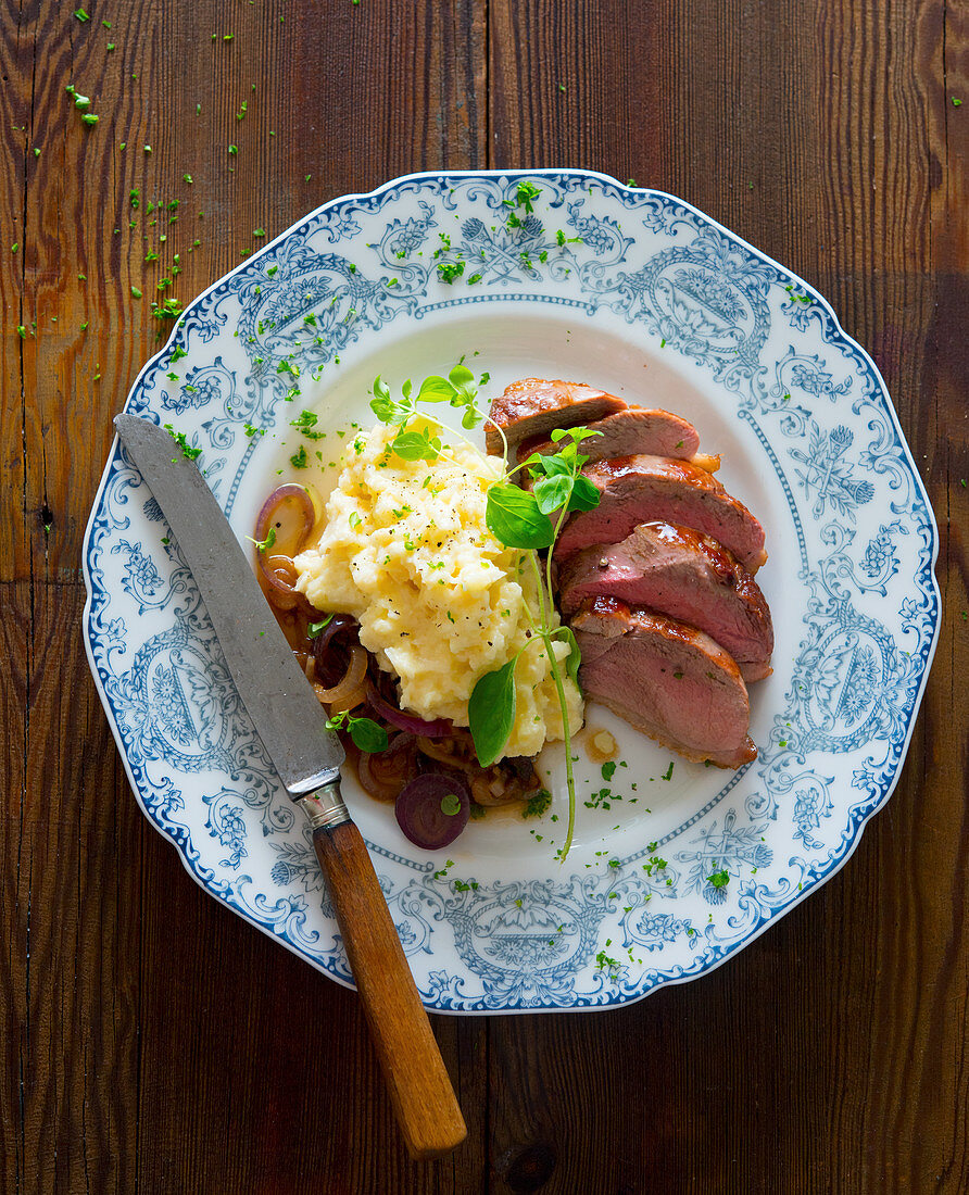 Duck breast with mashed potatoes and roasted onions