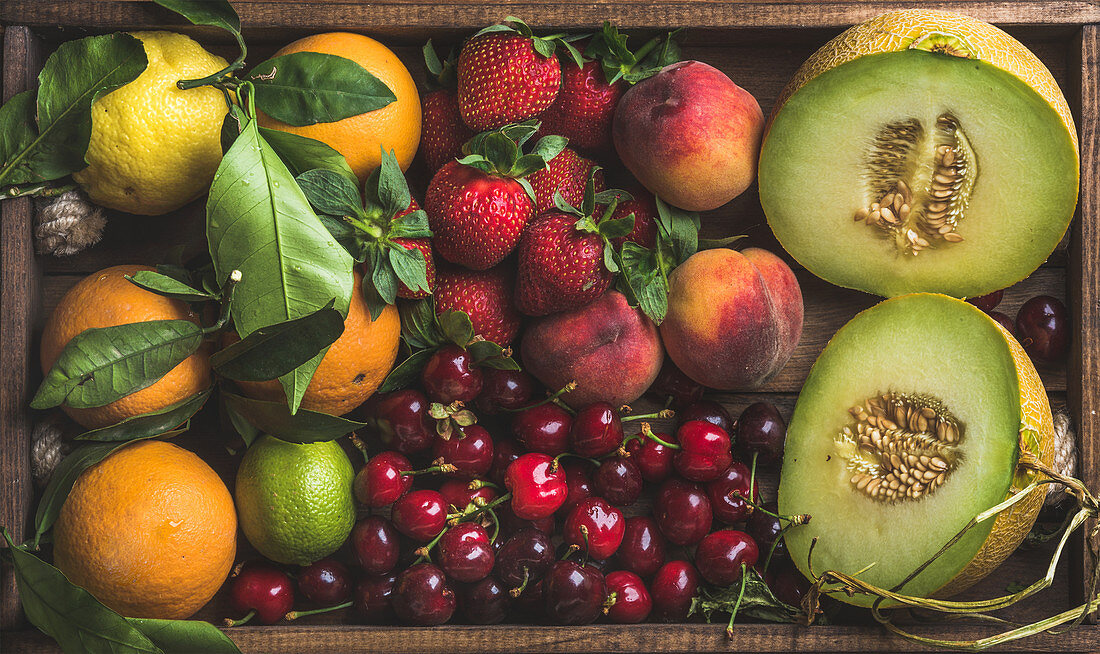 Healthy summer fruit variety - Melon, sweet cherries, peach, strawberry, orange and lemon