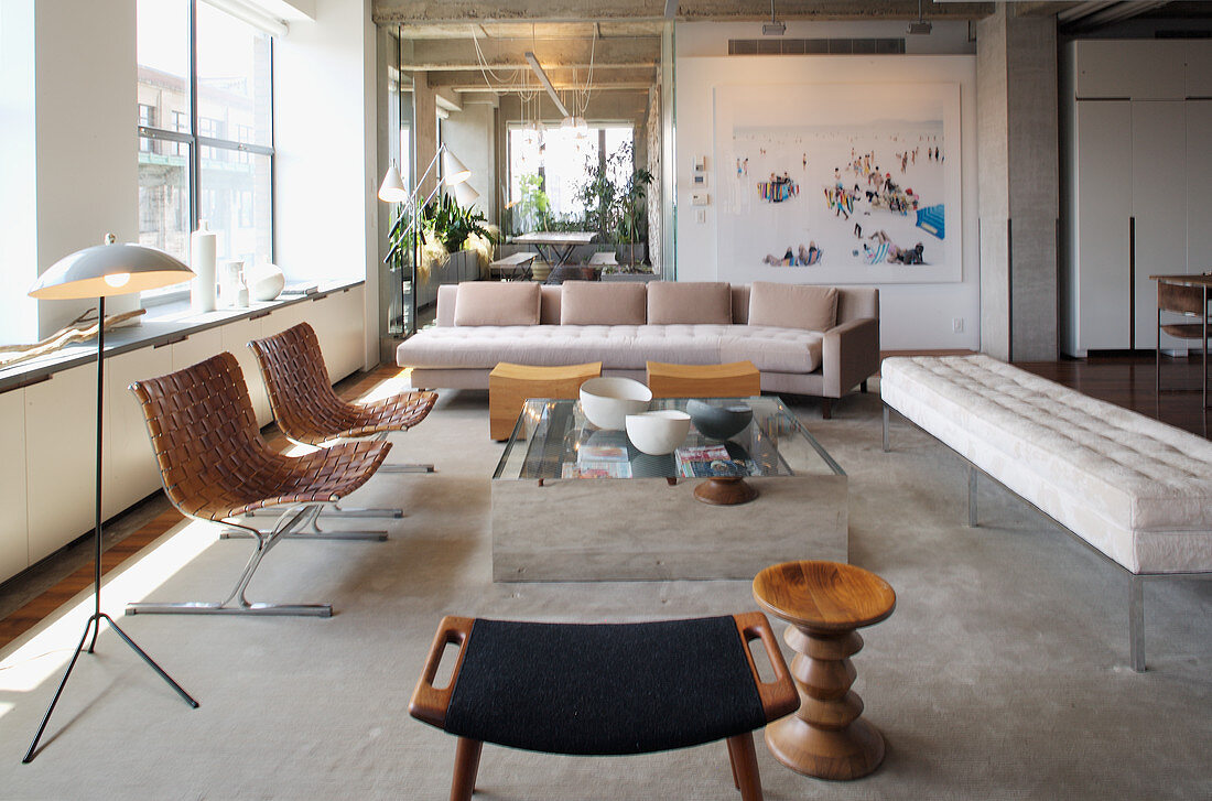 Elegante Lounge mit hellen Polstermöbeln und Designerstühlen