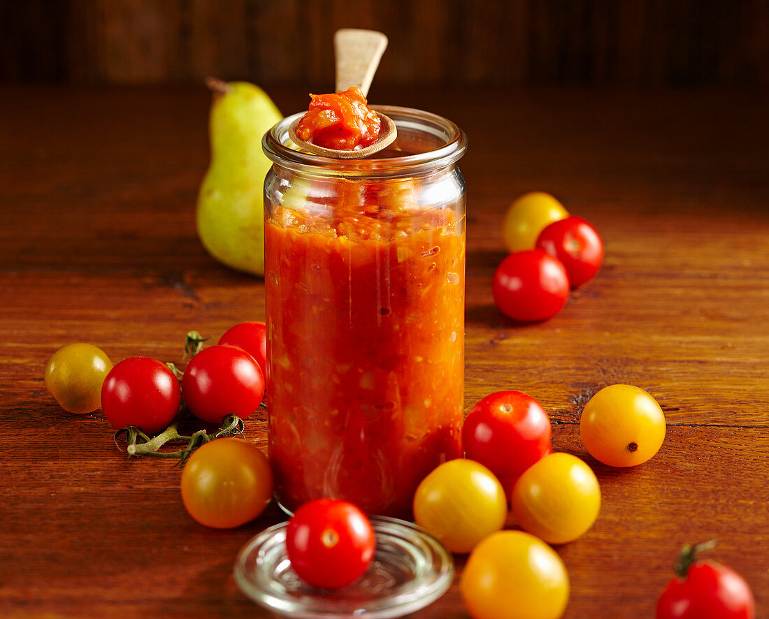 Homemade tomato chutney with pear, ginger, vinegar, cherry tomatoes, chili, cilantro, cloves and thyme