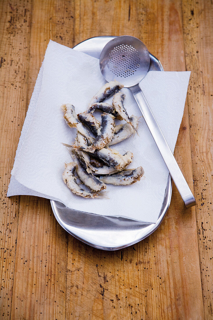 Fried sardines on kitchen towel