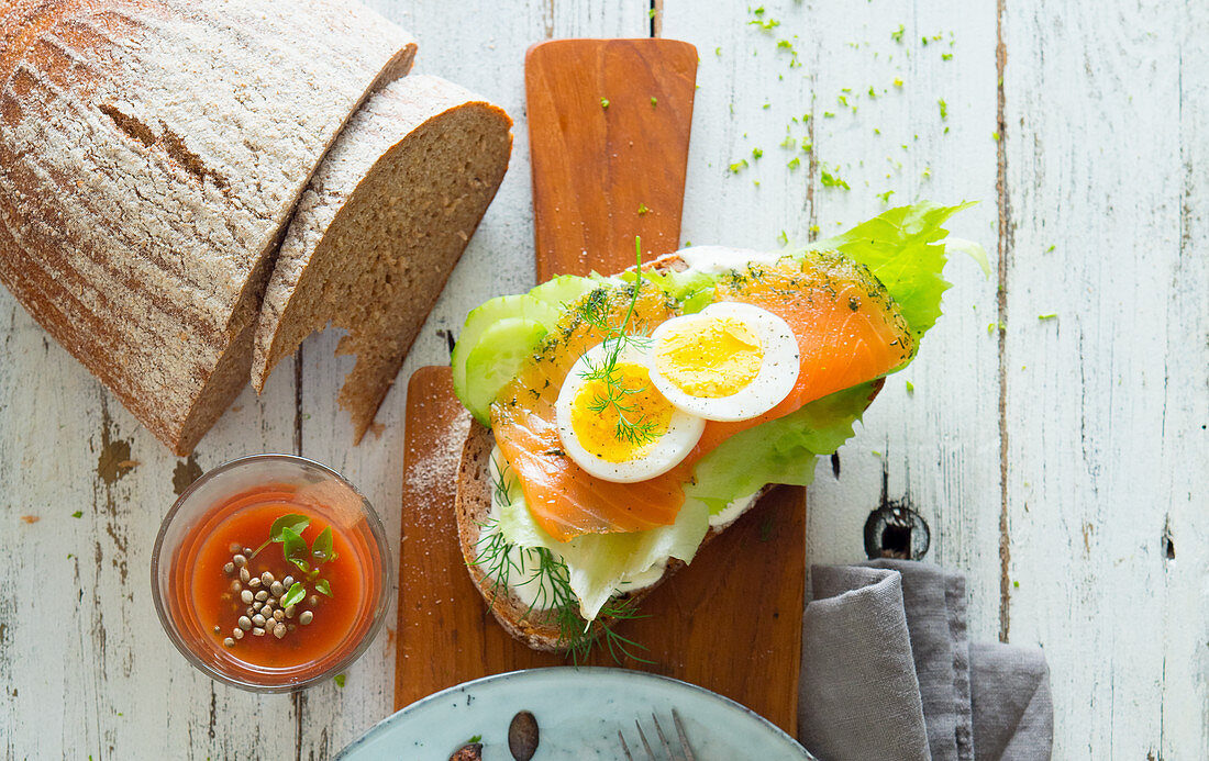 An open salmon sandwich with egg