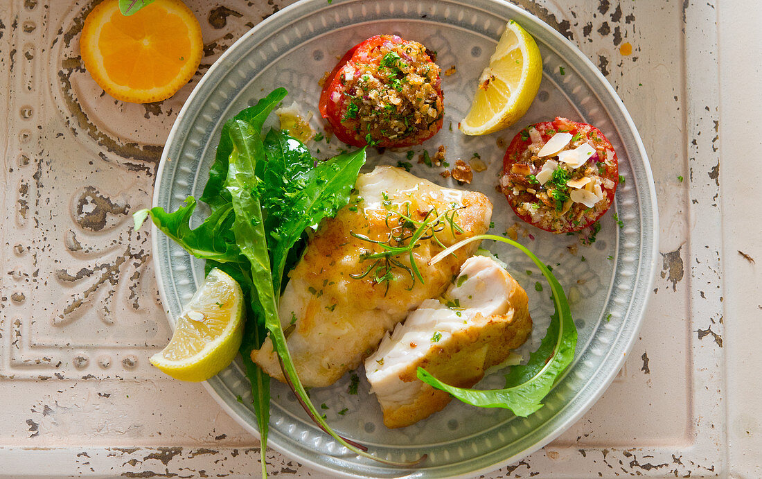 Mediterranean coalfish served with stuffed tomatoes and a dandelion salad