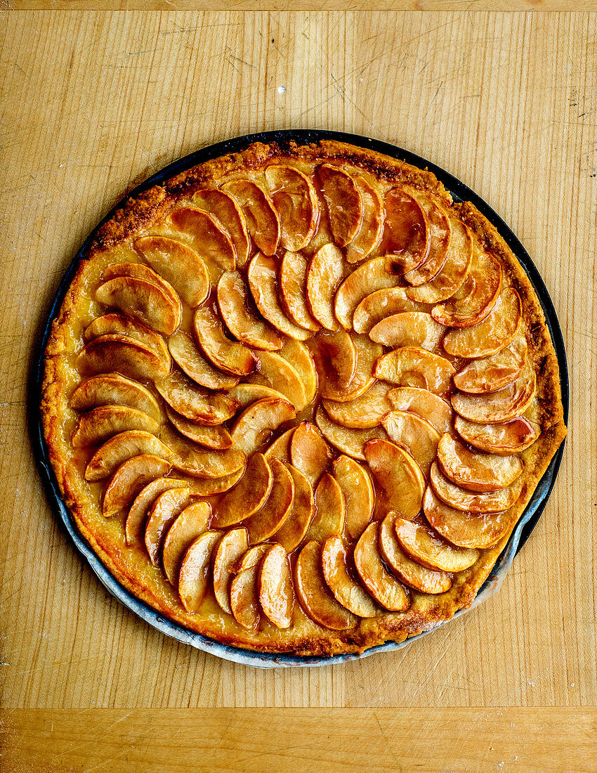 Apple tart on a wooden table (seen from above)