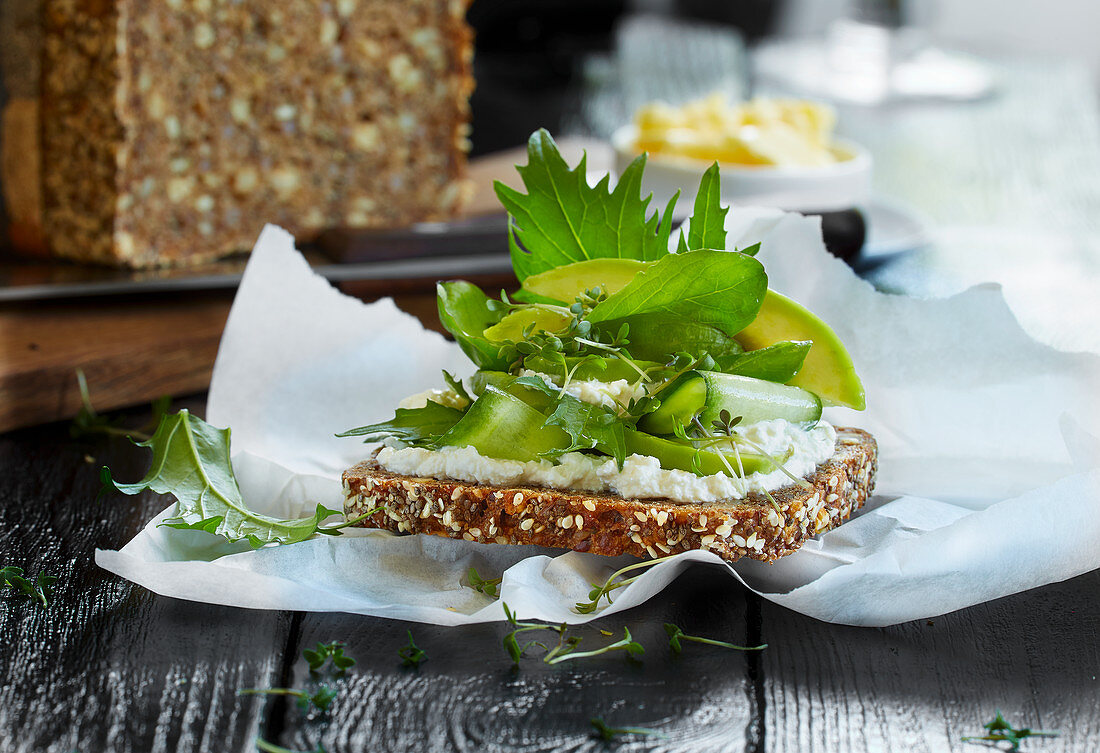 A slice of wholemeal bread with ricotta and avocado