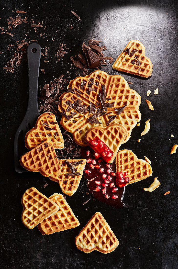 Waffles with grated chocolate and pomegranate seeds (seen from above)