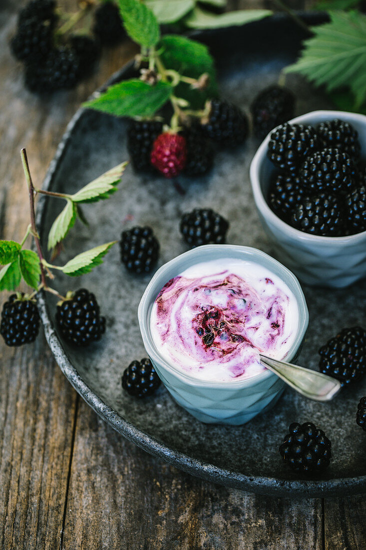 Blackberry yoghurt and fresh blackberries in two bowls