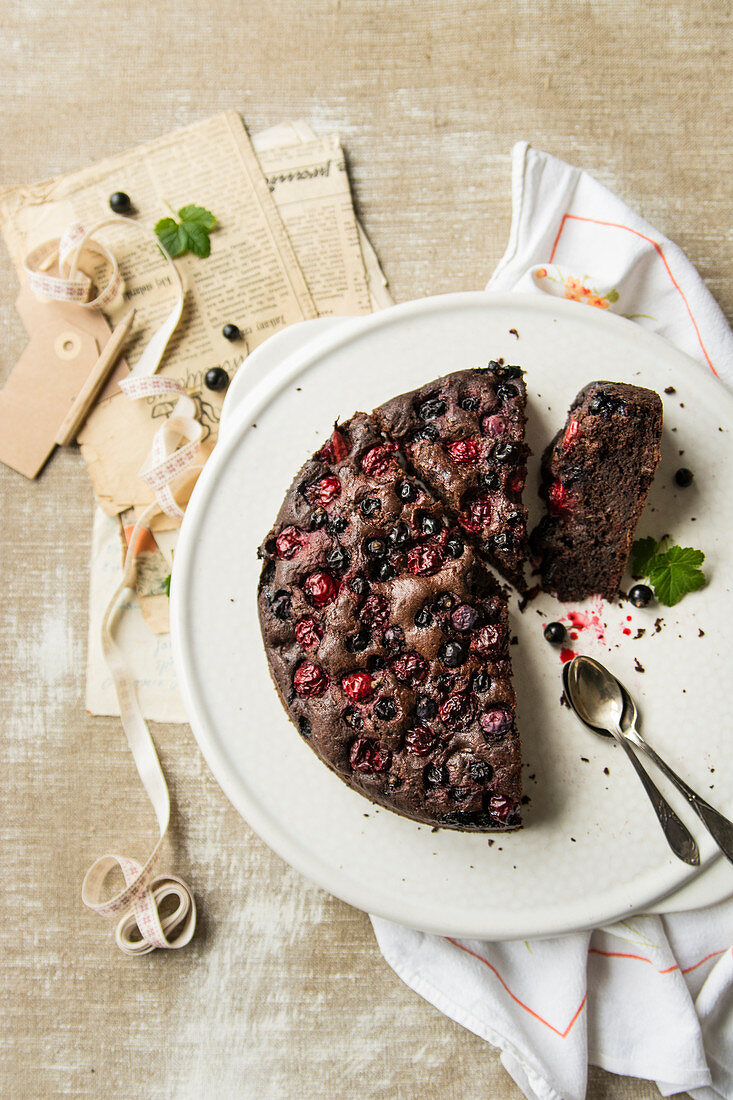 Chocolate cake with zucchini, baked with cherries and currants