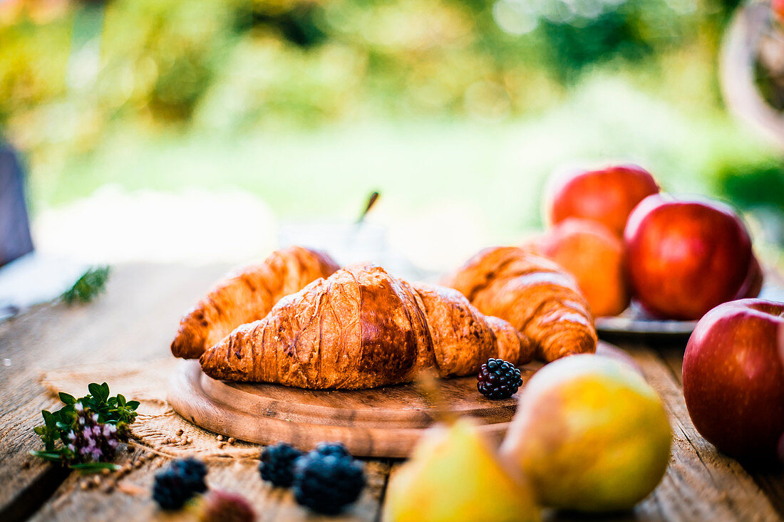 Croissants on table with fresh fruit