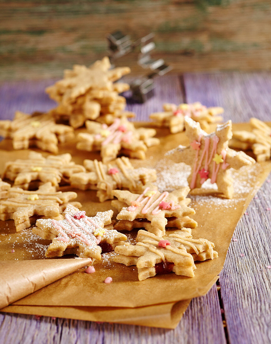 Cinnamon biscuits filled with plum jam on baking paper