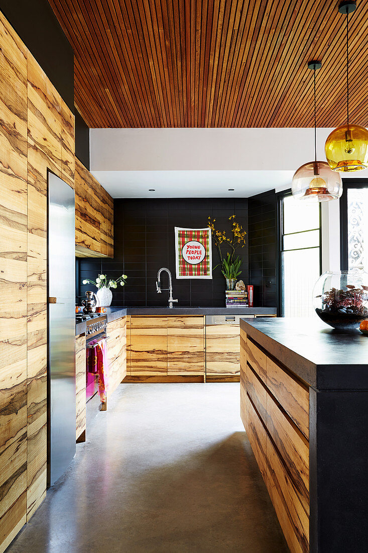 Open kitchen with wooden fronts and concrete floors