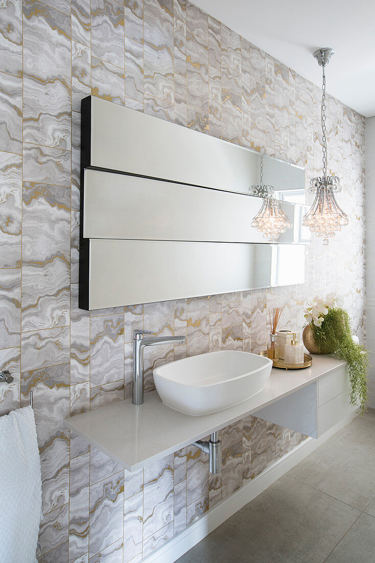 Modern mirror on staggered levels above sink