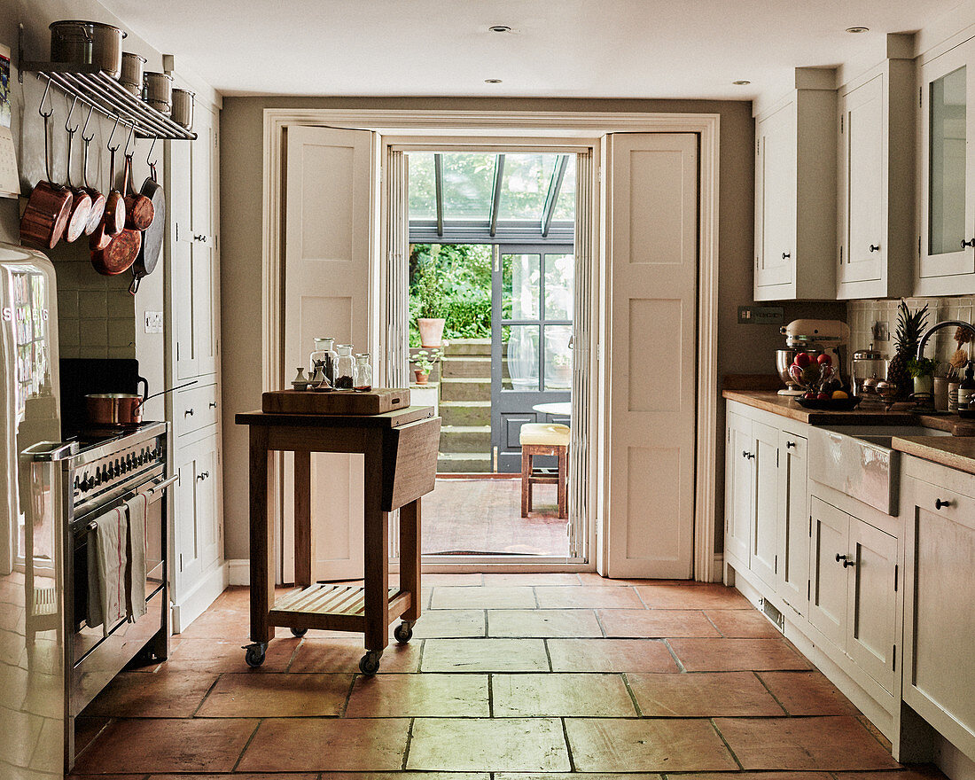 Terracotta floor tiles in country-house kitchen