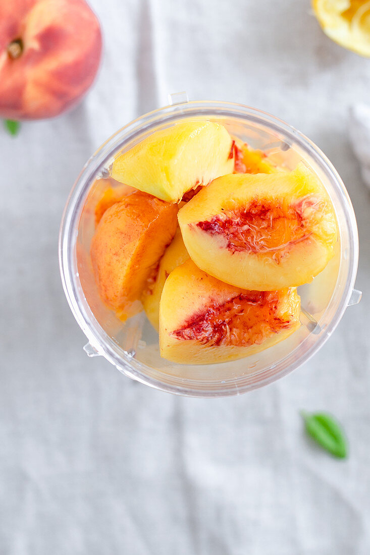 Peeled peach pieces in a blender