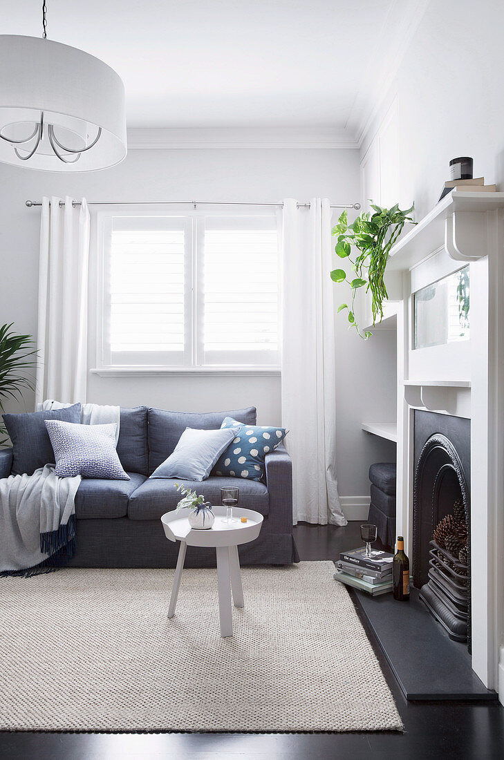 Living room in gray and white with an open fireplace