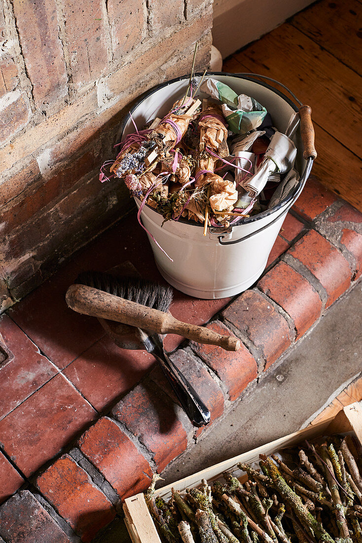 Bundles of kindling and herbs tied with raffia in bucket