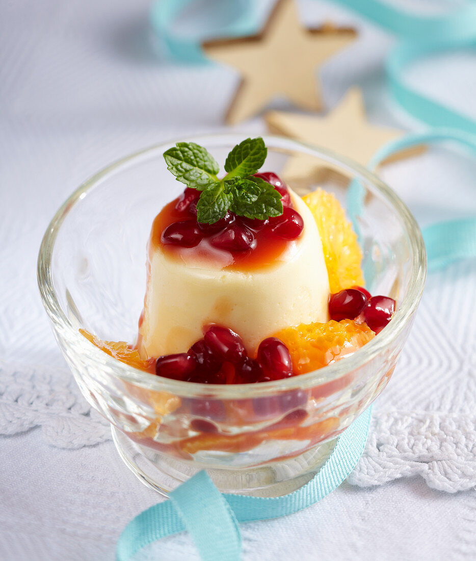 White chocolate mousse with pomegranate and mandarin sauce in a glass