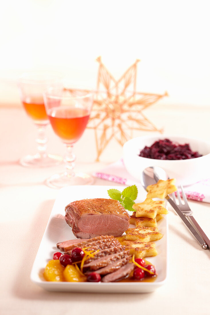 Rare duck breast with a fruity orange and cranberry sauce, fried potato stats and red cabbage