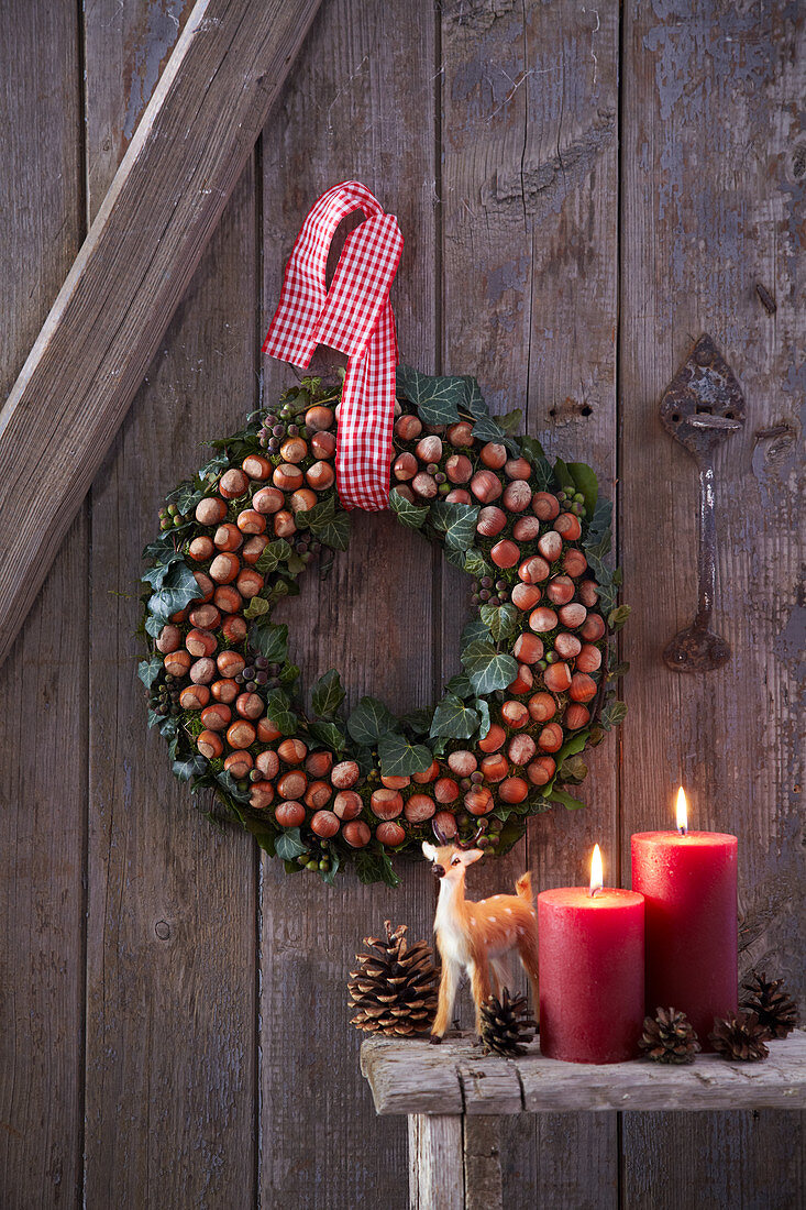 Festive wreath of hazelnuts and ivy on wall