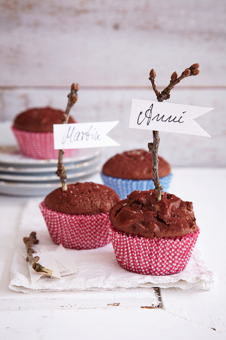 Spiced muffins decorated with name tags on twigs