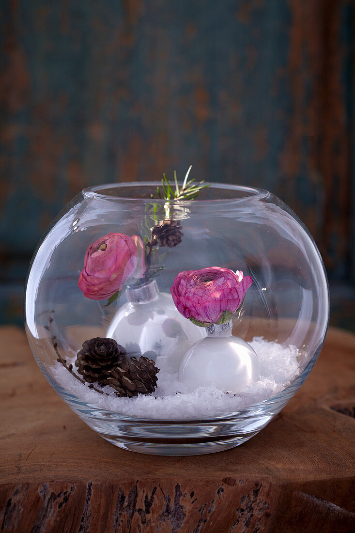 DIY snow globe decorated with ranunculus and larch twigs