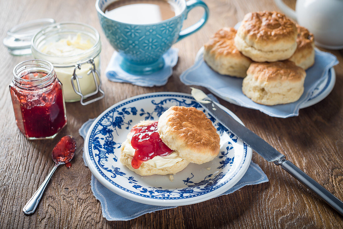Scones with strawberry jam and clotted cream and tea