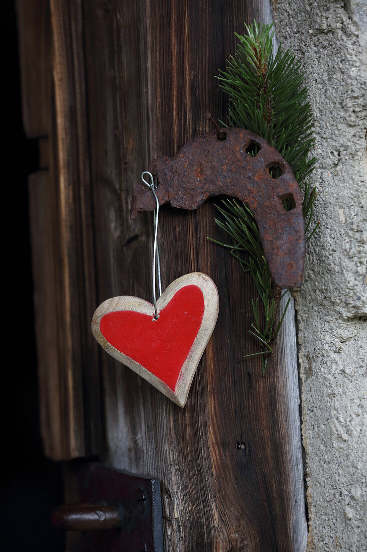 Heart pendant hung on wooden door
